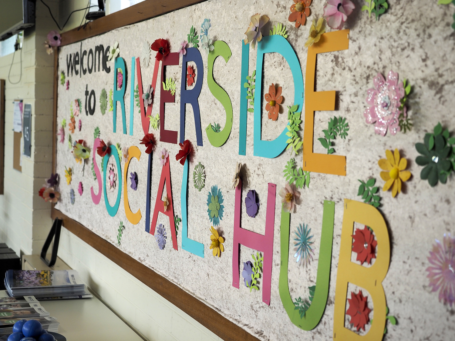 A custom made sign that says Welcome to Riverside Social Hub