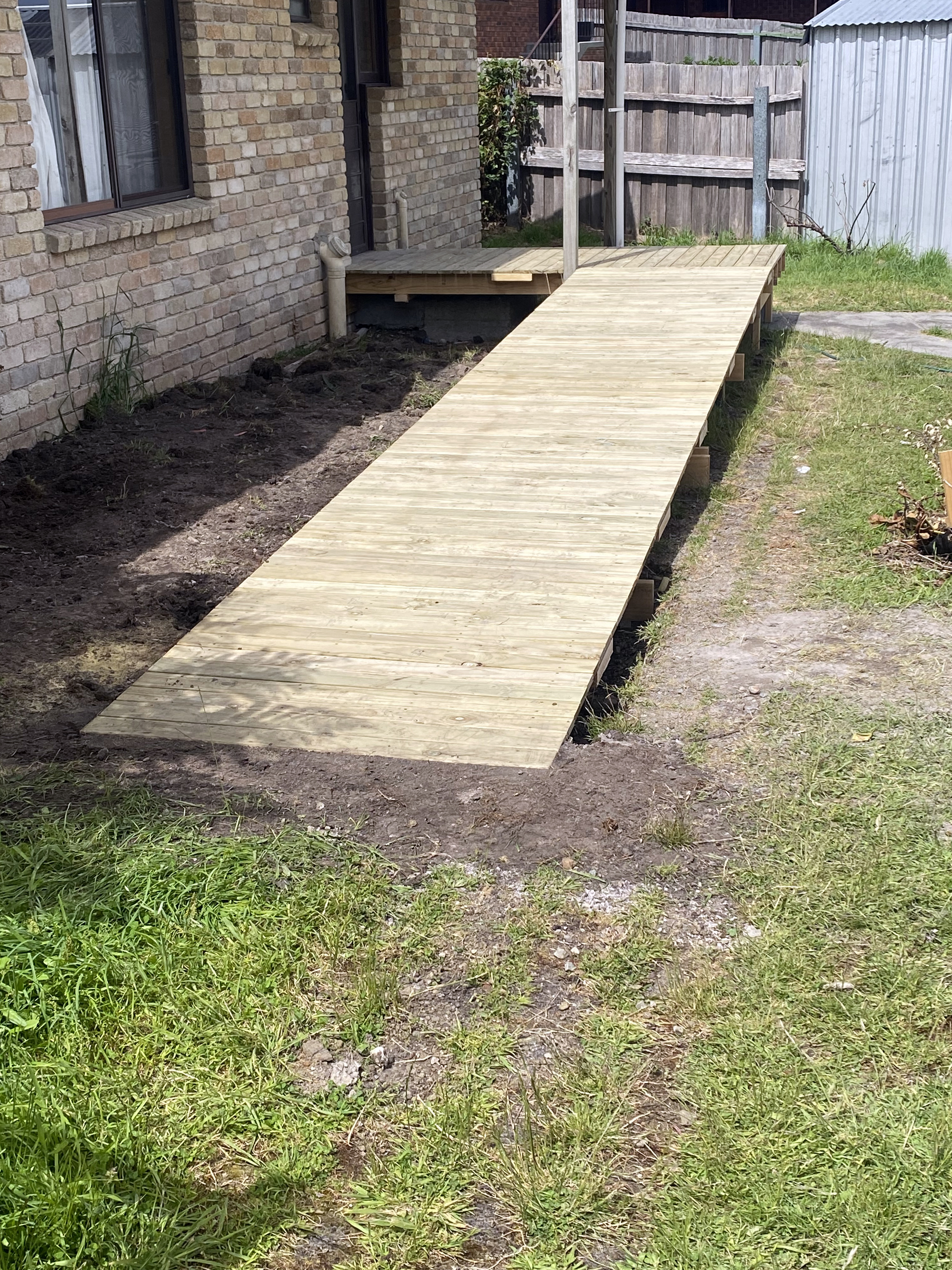 A wheelchair ramp under construction outside a home